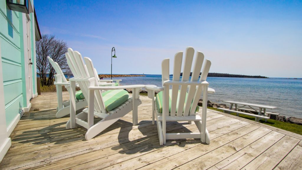 Chairs on a wooden deck with a view of Lake Huron