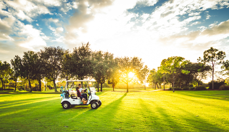 Father and daughter drive golf cart