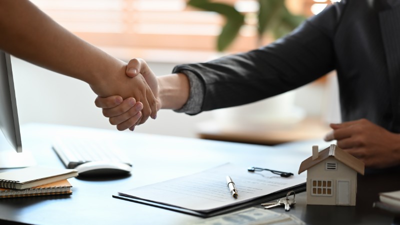 Realtor shaking hands with his client